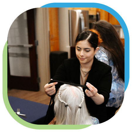 A senior gets her hair braided by a skilled hair stylist.