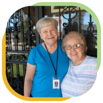 A Seniors Resource Center caregiver smiles for a picture with her patron.