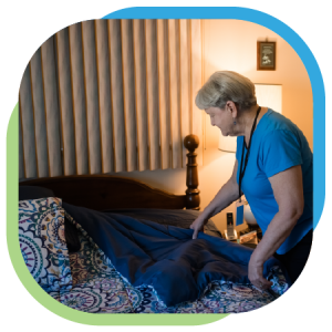 Bedding is washed and replaced in a private home of an SRC patron by a caregiver.